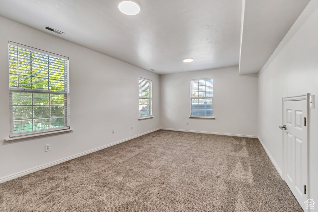 Unfurnished room featuring carpet floors and baseboards