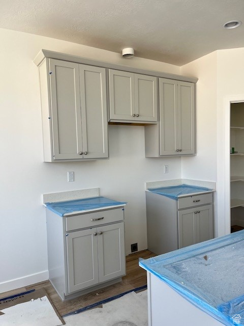 Laundry area with light wood-style flooring