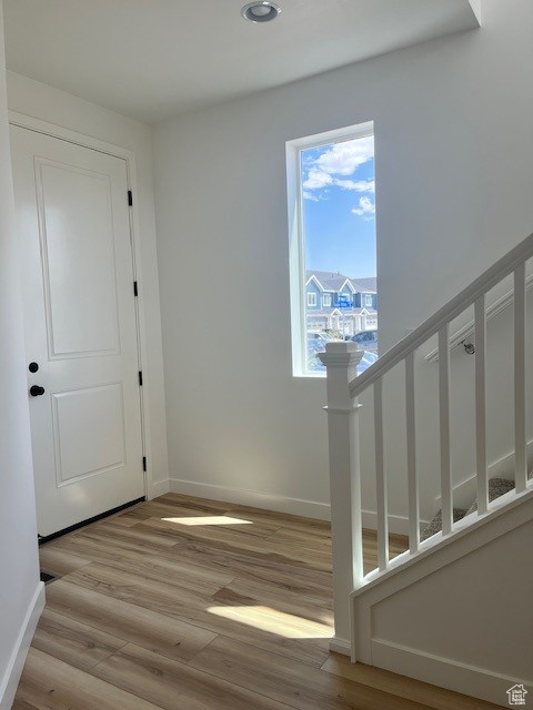 Entryway featuring light wood finished floors, recessed lighting, and stairway