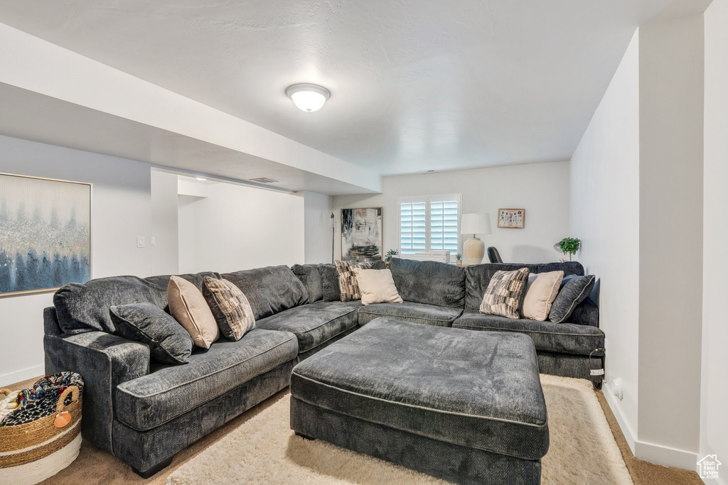 Carpeted living area with baseboards