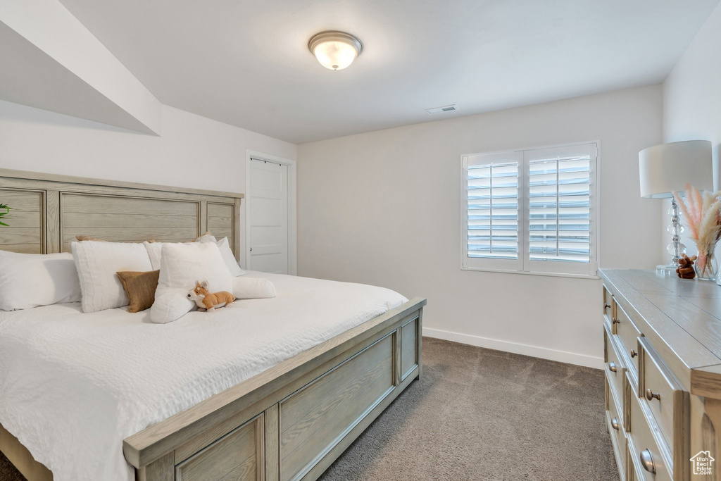 Bedroom featuring baseboards and dark colored carpet