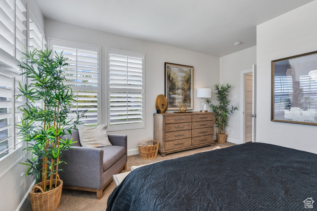 Bedroom featuring carpet floors and baseboards