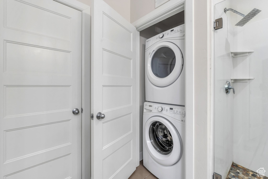 Laundry room featuring stacked washer / drying machine