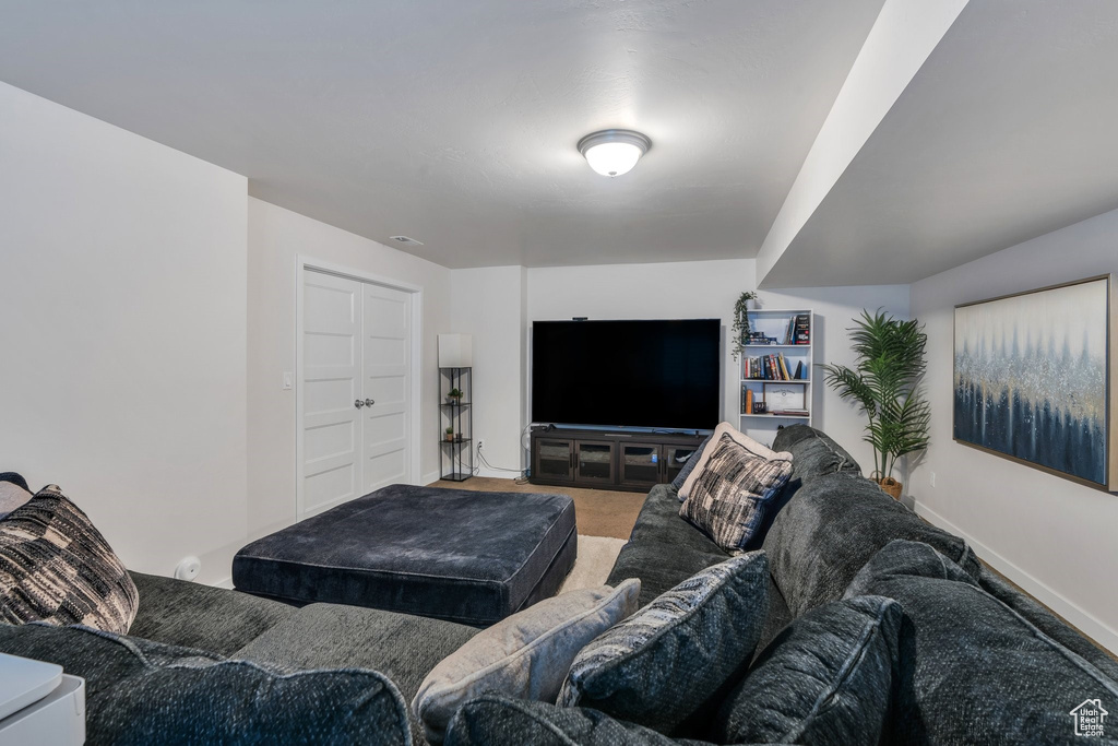 Carpeted living area featuring baseboards