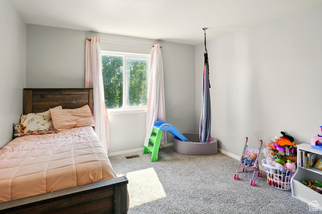 Bedroom featuring carpet flooring and baseboards