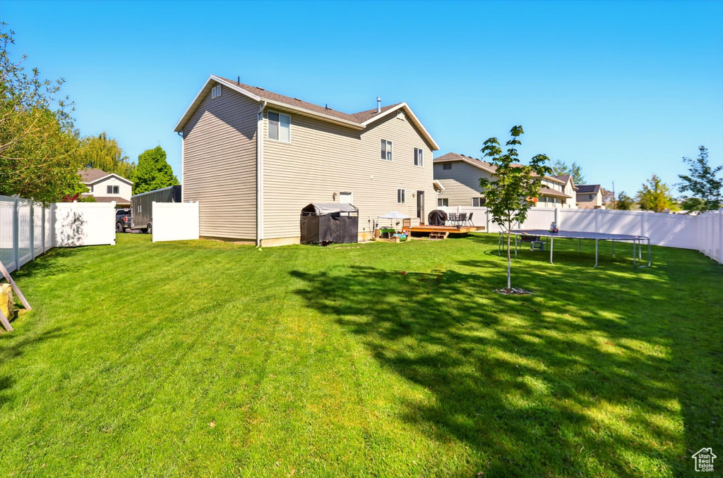 Back of property featuring a trampoline
