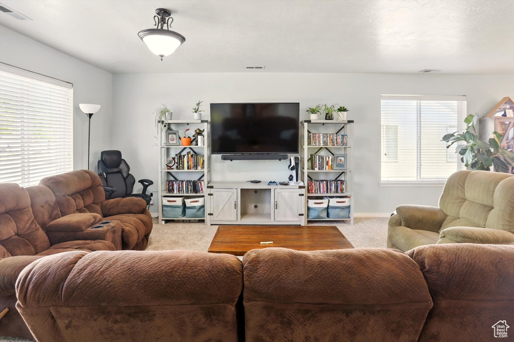 Living room with light carpet and baseboards