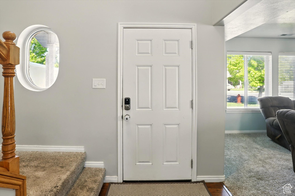 Entrance foyer with baseboards and stairway