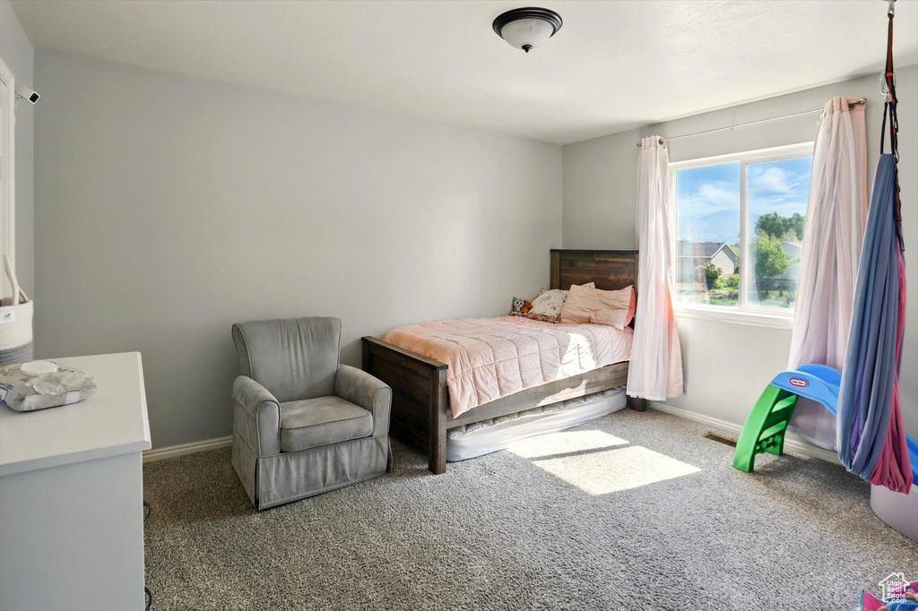 Bedroom with carpet flooring and baseboards