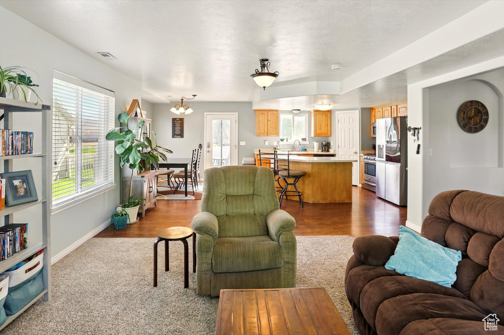 Living room with baseboards and dark wood-type flooring