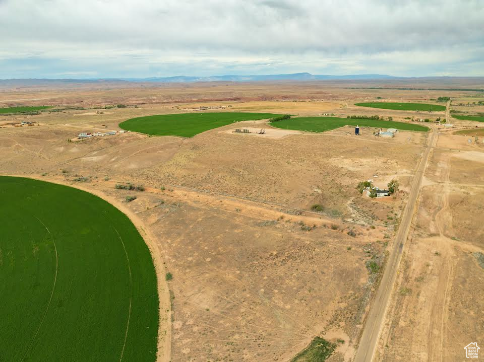 Aerial overview of property's location with rural landscape and a mountain backdrop