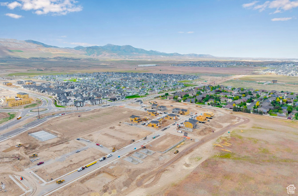 Aerial view of property and surrounding area with mountains and nearby suburban area