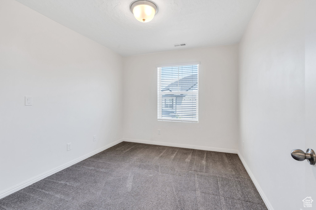 Empty room with carpet floors and baseboards