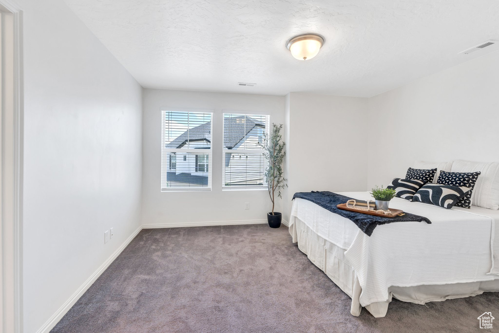 Bedroom featuring carpet floors and baseboards