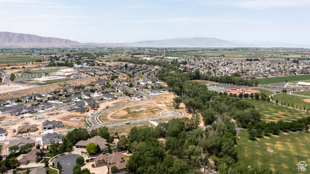 Aerial overview of property\'s location with a mountain backdrop and nearby suburban area