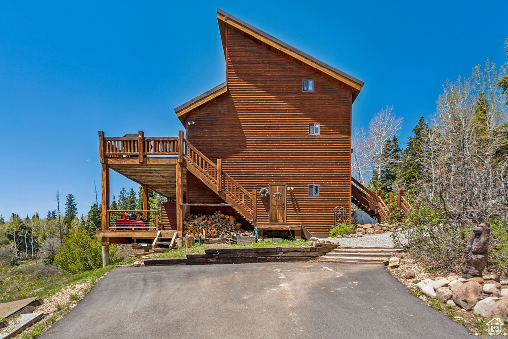 View of home\'s exterior featuring stairway and a deck