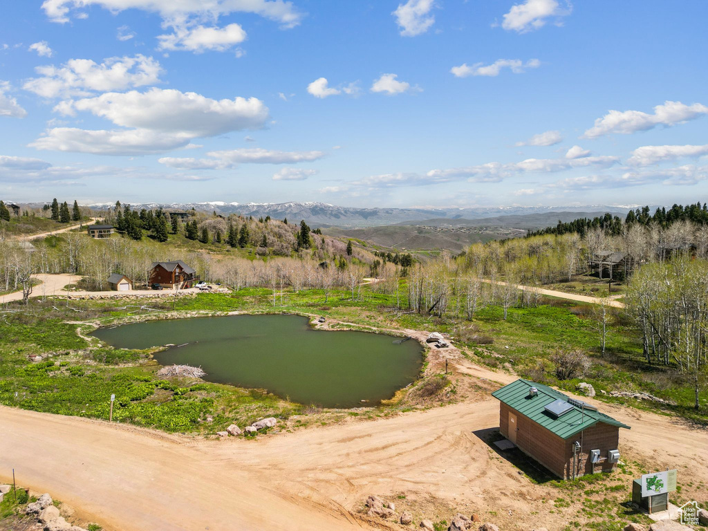 Surrounding community featuring a water and mountain view and an area to practice putting