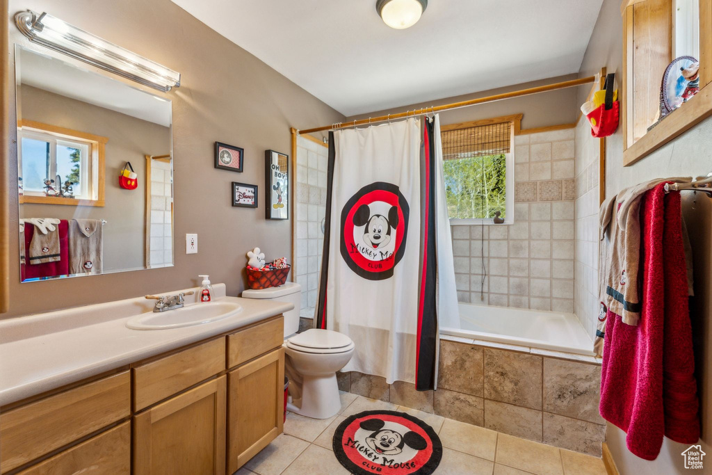 Full bathroom with healthy amount of natural light, tiled shower / bath combo, and tile patterned floors