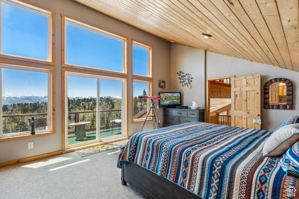 Bedroom with wooden ceiling, access to exterior, carpet flooring, high vaulted ceiling, and baseboards
