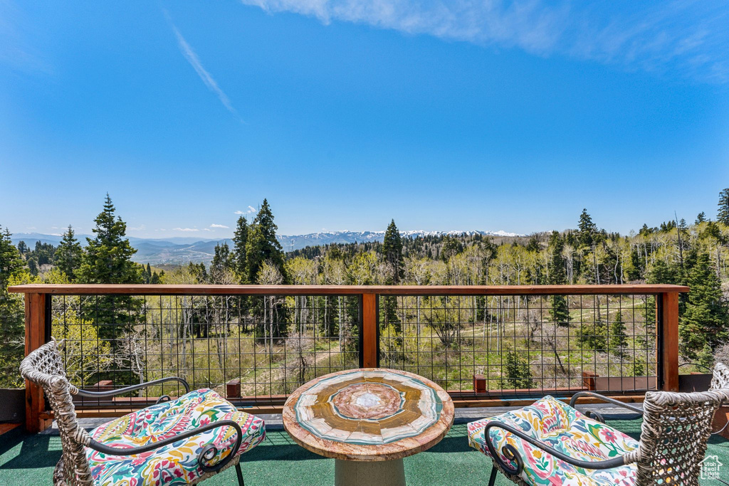 Balcony featuring a mountain view and a forest view