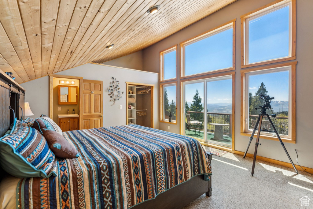 Carpeted bedroom with vaulted ceiling, access to exterior, wooden ceiling, and ensuite bath