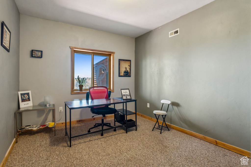 Carpeted office featuring baseboards