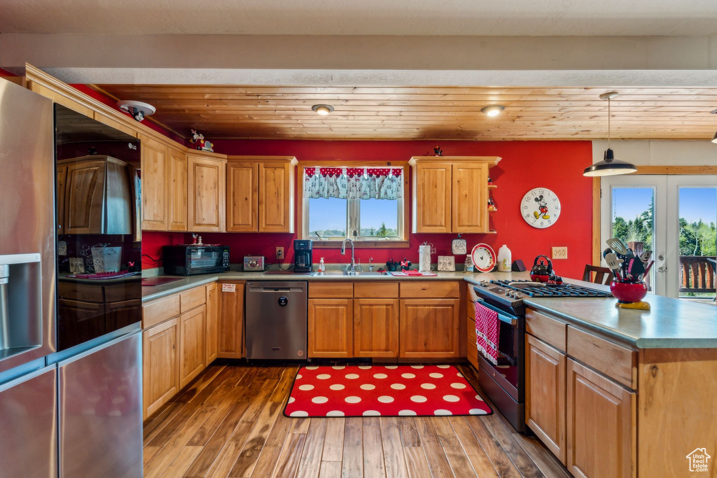 Kitchen featuring stainless steel appliances, a sink, healthy amount of natural light, and a peninsula