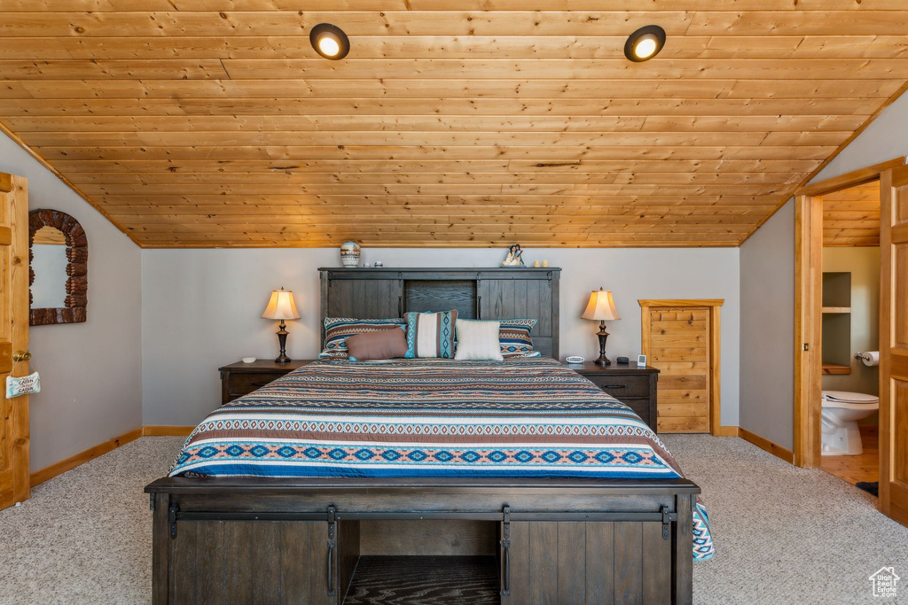 Carpeted bedroom with lofted ceiling, wood ceiling, and baseboards