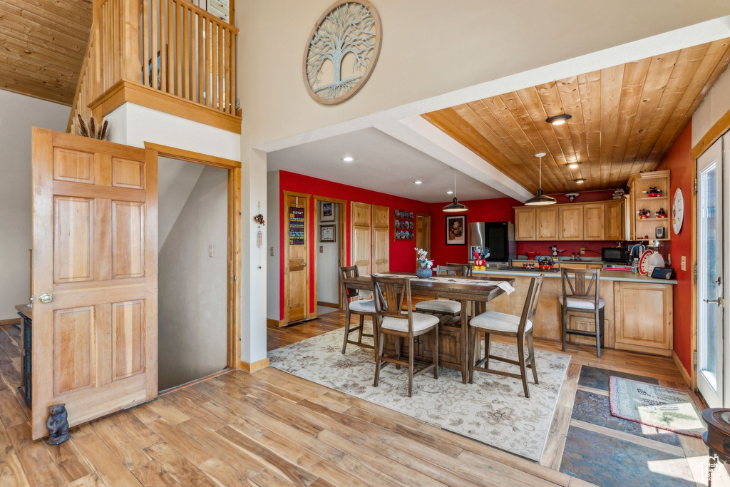 Dining area with wooden ceiling, light wood-style flooring, recessed lighting, and baseboards
