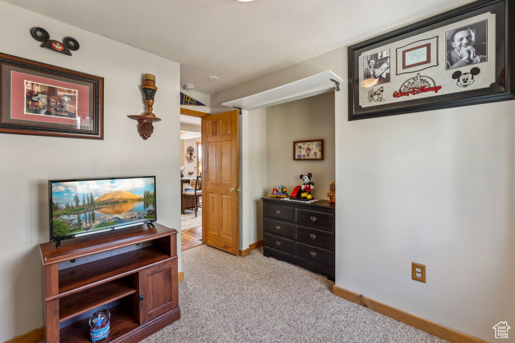 Living area with light colored carpet and baseboards