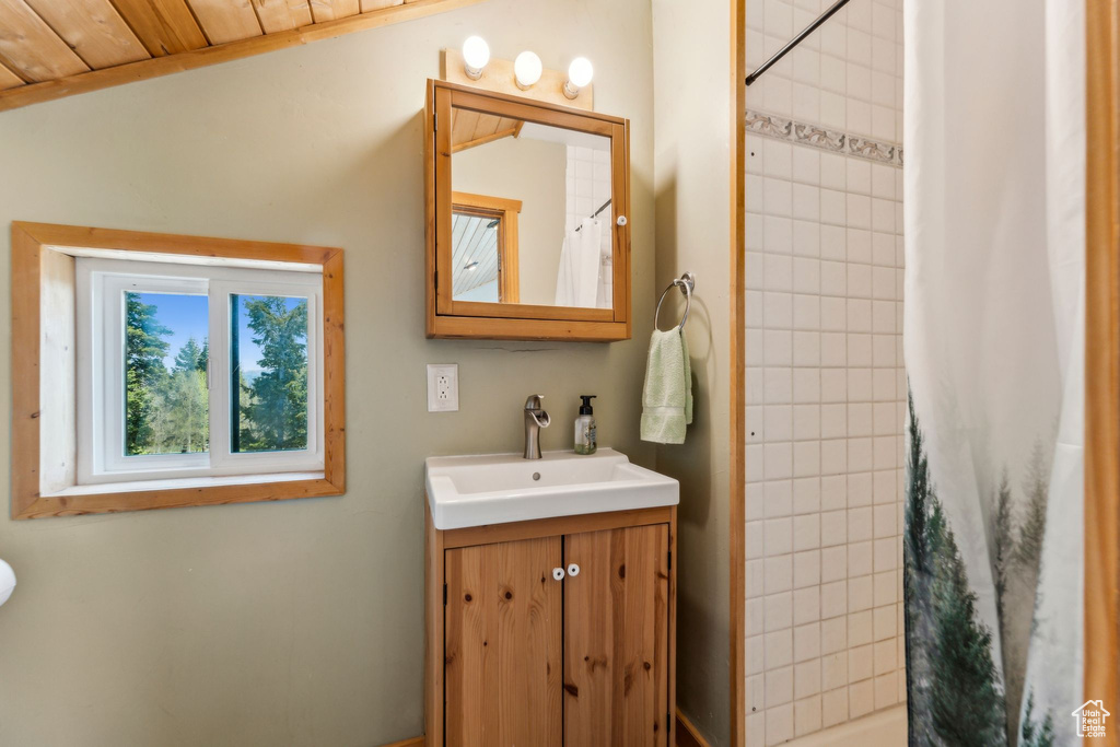 Bathroom featuring vanity and tiled shower
