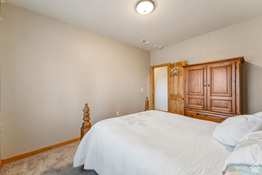 Bedroom with carpet flooring and baseboards