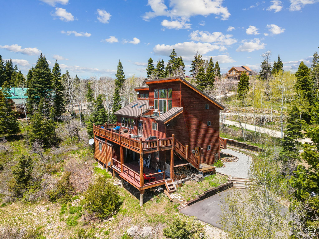 Back of property featuring a deck and stairway