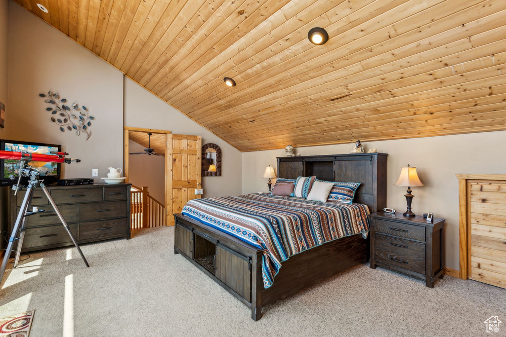 Carpeted bedroom with lofted ceiling and wood ceiling