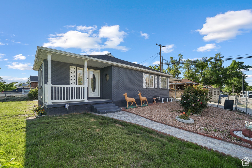 View of front of house featuring brick siding and a porch