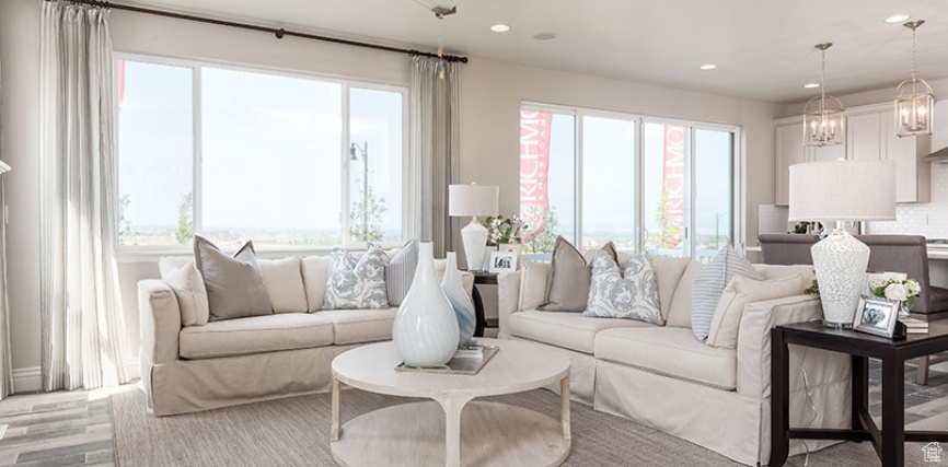 Living area with plenty of natural light, recessed lighting, and wood finished floors