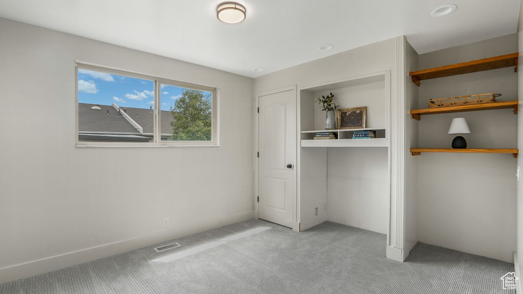 Unfurnished bedroom featuring light carpet