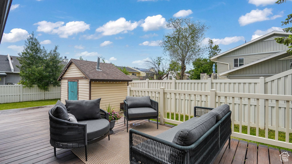 Wooden terrace with a fenced backyard, outdoor lounge area, and a residential view