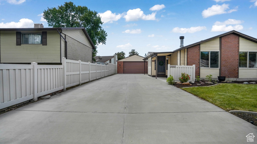 View of home's exterior with a garage and an outdoor structure