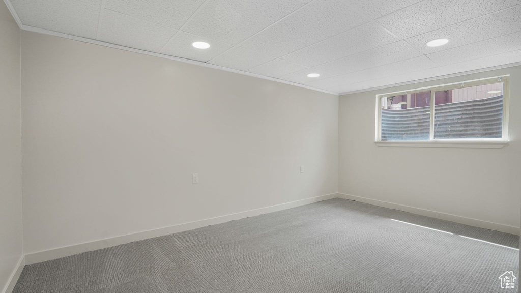 Carpeted spare room featuring baseboards and recessed lighting