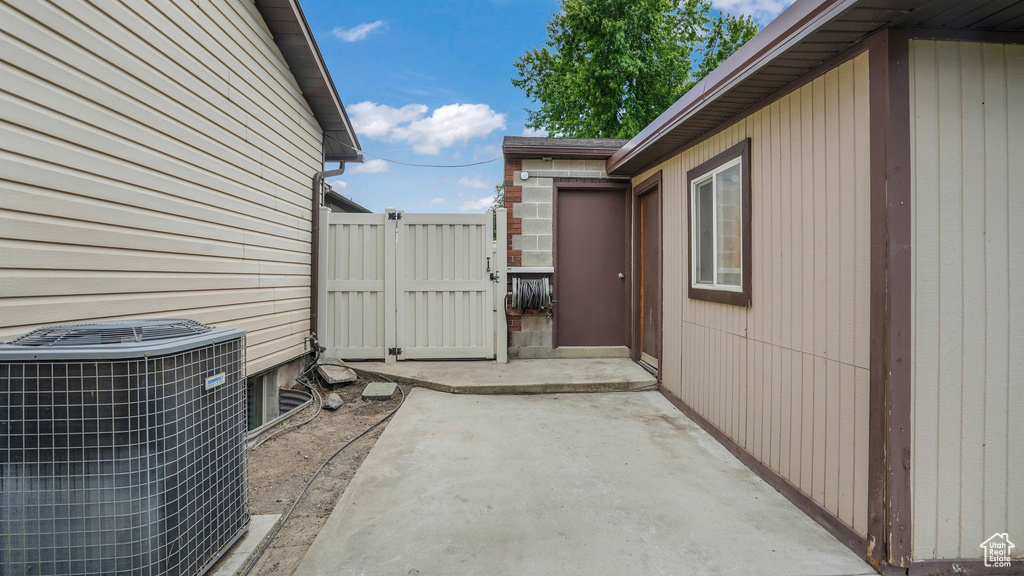 View of patio / terrace with cooling unit and a gate