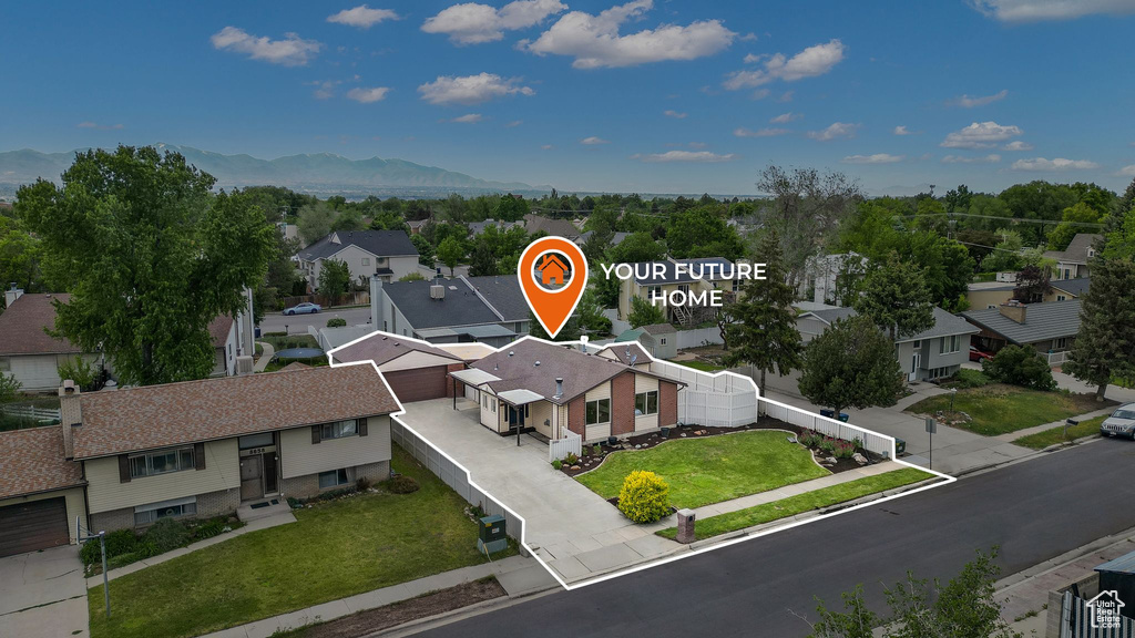 Aerial perspective of suburban area featuring a mountainous background