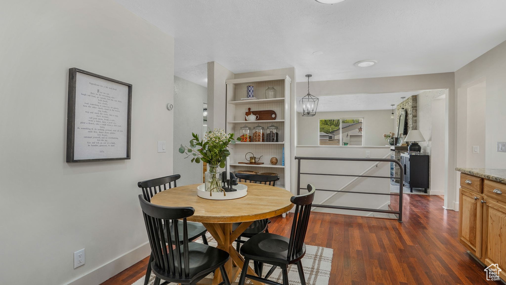 Dining area featuring dark wood finished floors and baseboards