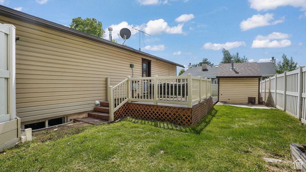 Rear view of house featuring a wooden deck