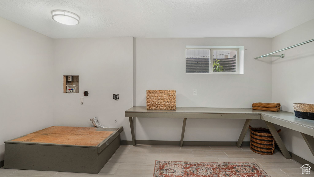 Laundry room with hookup for an electric dryer, washer hookup, and baseboards