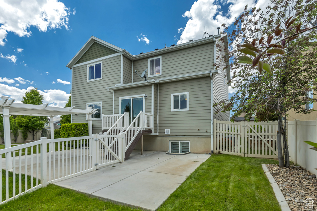 Back of property with a gate and a patio area