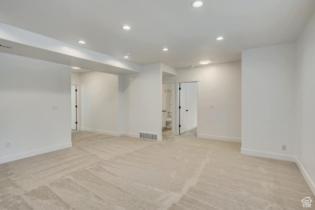 Finished basement with recessed lighting, light colored carpet, and baseboards