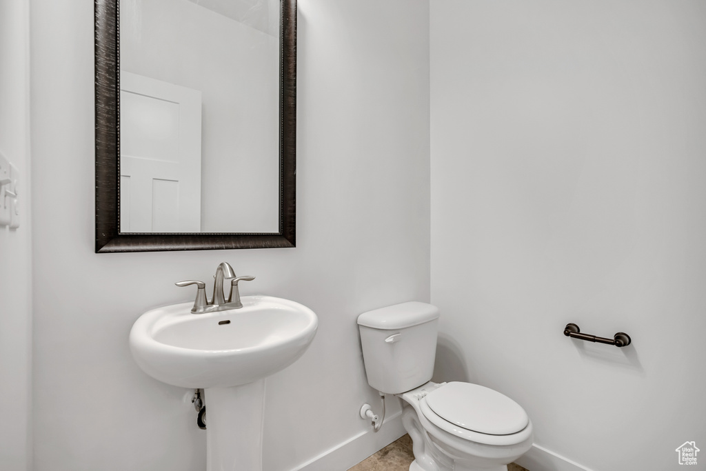 Bathroom with baseboards and toilet