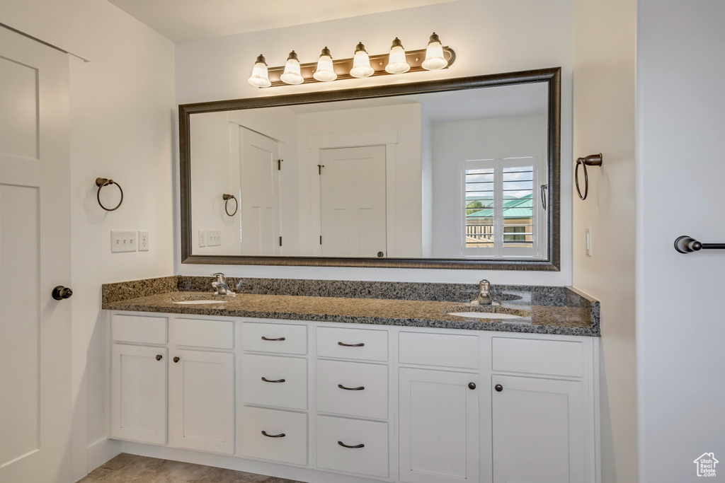 Full bath featuring double vanity