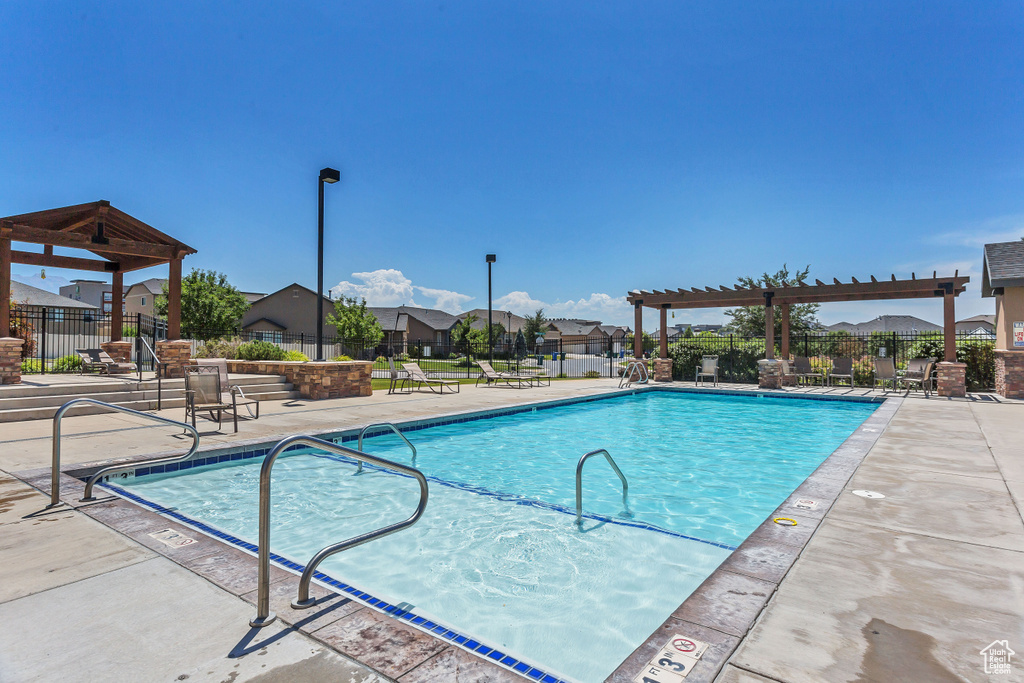 Community pool with a patio and a residential view